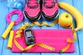 Glucometer, sport shoes, fresh fruits and accessories for fitness on blue boards, copy space for text Royalty Free Stock Photo