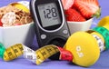 Glucometer with sugar level, healthy food, dumbbells and centimeter, diabetes, healthy and sporty lifestyle Royalty Free Stock Photo