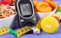 Glucometer with sugar level, healthy food, dumbbells and centimeter, diabetes, healthy and sporty lifestyle Royalty Free Stock Photo