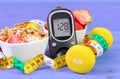 Glucometer with sugar level, healthy food, dumbbells and centimeter, diabetes, healthy and sporty lifestyle Royalty Free Stock Photo