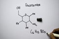 Glucosamine C6,H13,NO5 molecule written on the white board. Structural chemical formula. Education concept