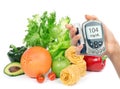 Glucose level blood test meter in hand and healthy organic food Royalty Free Stock Photo