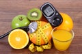 Glucose meter for checking sugar level, stethoscope, fruits, juice and centimeter Royalty Free Stock Photo