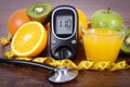 Glucometer, stethoscope, fruits, juice and centimeter, diabetes lifestyles and nutrition concept