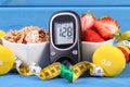 Glucometer with sugar level, healthy food, dumbbells and centimeter, diabetes, healthy and sporty lifestyle Royalty Free Stock Photo