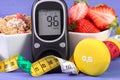 Glucometer with sugar level, healthy food, dumbbells and centimeter, diabetes, healthy and sporty lifestyle Royalty Free Stock Photo