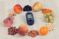 Glucose meter with result of measurement sugar level and healthy fruits, concept of diabetes and healthy nutrition