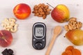 Glucose meter with sugar level and food as source minerals, vitamins and fiber, diabetes and healthy nutrition concept