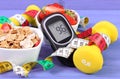 Glucose meter with sugar level, healthy food, dumbbells and centimeter, diabetes, healthy and sporty lifestyle Royalty Free Stock Photo