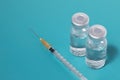 Close-up Syringe with two ampules on blue background Royalty Free Stock Photo