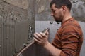 Gluing tiles on the wall. Laying tiles on the wall