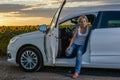 Glum woman sitting waiting for roadside assistance Royalty Free Stock Photo