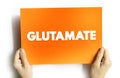Glutamate - abundant excitatory neurotransmitter released by nerve cells in your brain, text concept on card