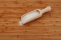 Glutamic acid monosodium salt in wooden scoop on wooden cutting board. Msg. Food additive E621. Flavor seasoning for enhancing Royalty Free Stock Photo