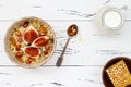 Gluten free amaranth and quinoa porridge breakfast bowl with figs, caramelized almonds, raisins and honey over rustic white table. Royalty Free Stock Photo