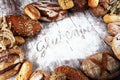 Gluten free breads, glutenfree word written and bread rolls on wooden background Royalty Free Stock Photo