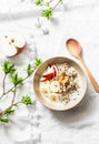 Gluten free breakfast - quinoa, coconut milk, banana, apple, peanut butter bowl on light background, top view. Delicious diet, veg Royalty Free Stock Photo