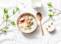 Gluten free breakfast - quinoa, coconut milk, banana, apple, peanut butter bowl on light background, top view. Delicious diet, veg Royalty Free Stock Photo