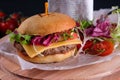 Gluten Free closeup homemade tasty burger on wooden board with organic beef, tomato, cheese and red onion. Delicious Royalty Free Stock Photo