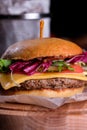 Gluten Free closeup homemade tasty burger on wooden board with organic beef, tomato, cheese and red onion. Delicious Royalty Free Stock Photo