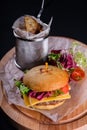 Gluten Free closeup homemade tasty burger on wooden board with organic beef, tomato, cheese and red onion. Delicious Royalty Free Stock Photo