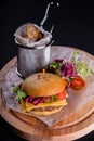 Gluten Free closeup homemade tasty burger on wooden board with organic beef, tomato, cheese and red onion. Delicious Royalty Free Stock Photo