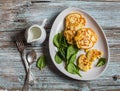 Gluten free corn fritters and fresh spinach on a wooden board Royalty Free Stock Photo