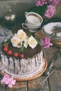 Gluten-free and dairy-free cake decorated with white roses and coconut: chocolate-nut biscuit, berry mousse, custard on almond mil