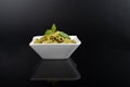 Gluten-free fresh cooked penne pasta from green peas isolated on black background, basil leaf top Royalty Free Stock Photo