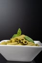 Gluten-free fresh cooked penne pasta from green peas isolated on black background, basil leaf top Royalty Free Stock Photo