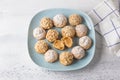 Gluten-free oat profiteroles with caramel cream of boiled condensed milk, sprinkled with powdered sugar and nuts on a