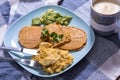 Gluten free pancakes with scrambled eggs and avocado