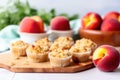 gluten-free peach muffins next to vibrant fresh peaches