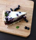 Gluten-free pie with blueberry and cream, cutted piece on board