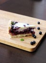 Gluten-free pie with blueberry and cream, cutted piece on board