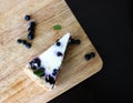 Gluten-free pie with blueberry and cream, top view, cutted piece on board