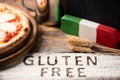 A gluten free pizza on  a rustic wood background Royalty Free Stock Photo