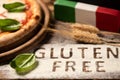 A gluten free pizza on  a rustic wood background Royalty Free Stock Photo