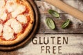 A gluten free pizza on  a rustic wood background Royalty Free Stock Photo