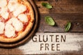 A gluten free pizza on  a rustic wood background Royalty Free Stock Photo