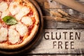 A gluten free pizza on  a rustic wood background Royalty Free Stock Photo