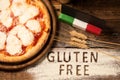 A gluten free pizza on  a rustic wood background Royalty Free Stock Photo