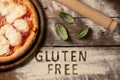 A gluten free pizza on  a rustic wood background Royalty Free Stock Photo