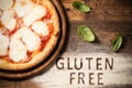 A gluten free pizza on a rustic wood background Royalty Free Stock Photo