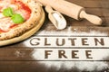 A gluten free pizza on a rustic wood background, with word Royalty Free Stock Photo