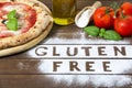 A gluten free pizza on a rustic wood background, with word Royalty Free Stock Photo