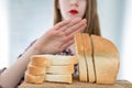 Gluten intolerance concept. Young girl refuses to eat white bread - shallow depth of field Royalty Free Stock Photo