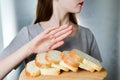 Gluten intolerance concept. Young girl refuses to eat white bread - shallow depth of field Royalty Free Stock Photo