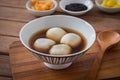 Glutinous rice balls filled with black sesame in sweet ginger soup