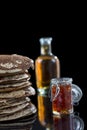 Glutten-free pancakes with jam and Maple syrup, bio healthy ingredients, on black